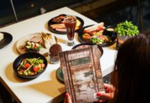 The World Café at Sheraton Grand Bangalore Hotel at Brigade Gateway Unveils a Vibrant New All- Day Dining Experience The World Café at Sheraton Grand Bangalore Hotel at Brigade Gateway Unveils a Vibrant New All-Day Dining Experience The World Café at Sheraton Grand Bangalore Hotel at Brigade Gateway has unveiled a refreshed all-day dining menu designed to complement different times of the day, offering guests a balanced mix of comfort favourites and wholesome dishes. At The World Café, every dish begins as a sketch—a spark, a playful idea waiting to leap off the page. Drawing inspiration from global flavours, our new menu unfolds like a comic strip, where every frame tells its own story and every bite brings the plot to life. Designed for busy days and quick conversations, this comic-inspired dining experience adds color, creativity, and a touch of fun to corporate meals, making every moment truly enjoyable. The breakfast selection features freshly brewed coffees alongside classics such as Eggs Your Way, The Big English, and the Vegan Jogger’s Breakfast. Guests can also choose from sweet offerings, including Maple French Toast, Coconut Pancakes, and a variety of freshly baked croissants, muffins, cookies and pastries. For lighter meals, the menu introduces options such as the Acai Bowl, Mixed Quinoa Bowl, and Feta & Zhoug Fattoush, along with popular snacks like samosas and puffs. Lunch offerings include café staples such as the Caprese Panini, Bombay Sandwich, and Vegan Burger, complemented by mains like Truffle & Mushroom Penne and Chilli & Garlic Linguine. The beverage menu features fresh fruit juices, smoothies, cold coffees, and signature cold brews. Evenings offer a relaxed setting with wine by the glass and handcrafted sangrias. With its refreshed menu and contemporary ambience, The World Café continues to position itself as a convenient dining destination for casual breakfasts, business lunches, and relaxed evening gatherings. New-Menu-Launch-at-The-World-Cafe-Sheraton-Brigade