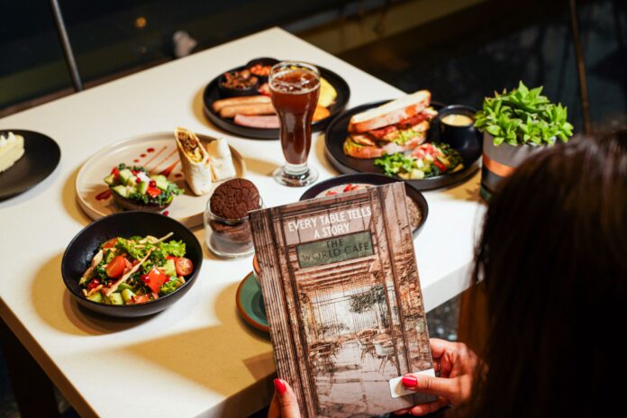 New Menu Launch at The World Cafe - Sheraton Brigade The World Café at Sheraton Grand Bangalore Hotel at Brigade Gateway Unveils a Vibrant New All-Day Dining Experience The World Café at Sheraton Grand Bangalore Hotel at Brigade Gateway has unveiled a refreshed all-day dining menu designed to complement different times of the day, offering guests a balanced mix of comfort favourites and wholesome dishes. At The World Café, every dish begins as a sketch—a spark, a playful idea waiting to leap off the page. Drawing inspiration from global flavours, our new menu unfolds like a comic strip, where every frame tells its own story and every bite brings the plot to life. Designed for busy days and quick conversations, this comic-inspired dining experience adds color, creativity, and a touch of fun to corporate meals, making every moment truly enjoyable. The breakfast selection features freshly brewed coffees alongside classics such as Eggs Your Way, The Big English, and the Vegan Jogger’s Breakfast. Guests can also choose from sweet offerings, including Maple French Toast, Coconut Pancakes, and a variety of freshly baked croissants, muffins, cookies and pastries. For lighter meals, the menu introduces options such as the Acai Bowl, Mixed Quinoa Bowl, and Feta & Zhoug Fattoush, along with popular snacks like samosas and puffs. Lunch offerings include café staples such as the Caprese Panini, Bombay Sandwich, and Vegan Burger, complemented by mains like Truffle & Mushroom Penne and Chilli & Garlic Linguine. The beverage menu features fresh fruit juices, smoothies, cold coffees, and signature cold brews. Evenings offer a relaxed setting with wine by the glass and handcrafted sangrias. With its refreshed menu and contemporary ambience, The World Café continues to position itself as a convenient dining destination for casual breakfasts, business lunches, and relaxed evening gatherings. New-Menu-Launch-at-The-World-Cafe-Sheraton-Brigade