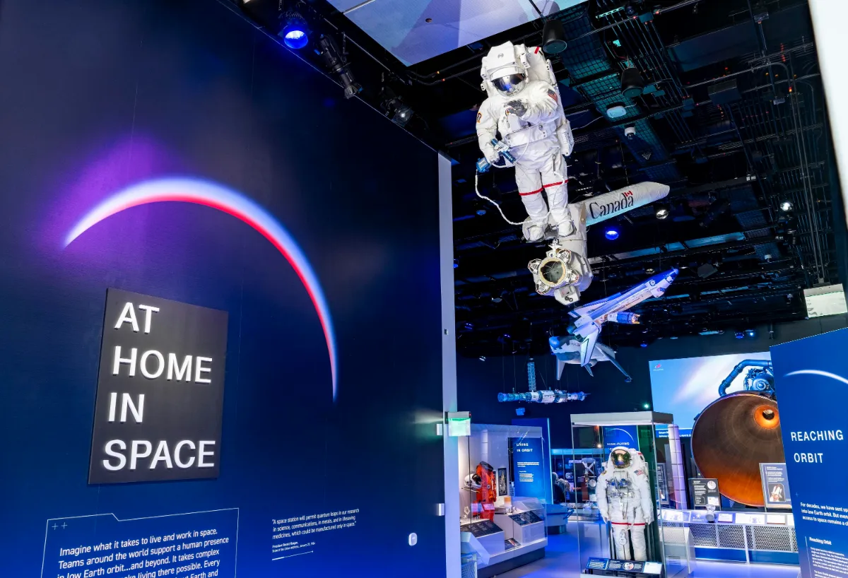Entrance to the At Home in Space gallery with a spacesuit on a robotic arm, National Air and Space Museum