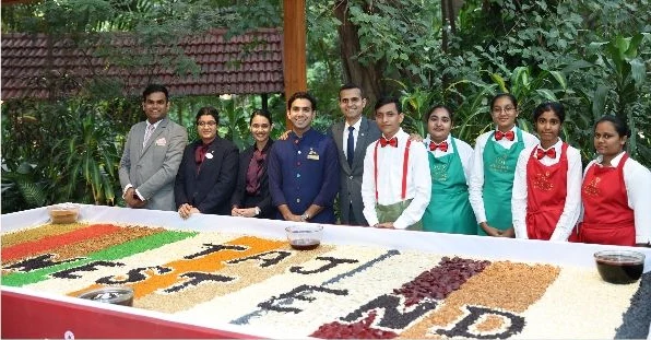 The Taj West End team with the cake-mixing tray of dried fruits and nuts