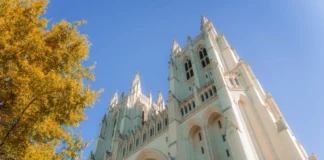 Washington National Cathedral with autumn foliage and a blue sky